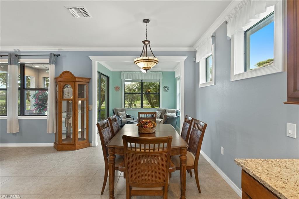 6085 Triumph Lane Ave Maria, FL 34142 - Photo 13 of 42 a dining room with furniture a chandelier and window