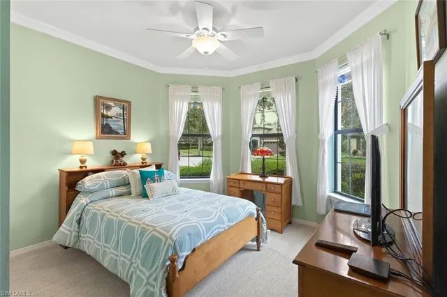 a bedroom with a large bed and a large window