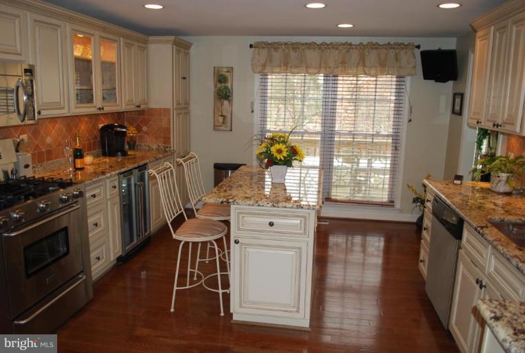 1532 Deer Point Way Reston, VA 20194 - Photo 4 of 19 a kitchen with stainless steel appliances granite countertop a stove and a sink