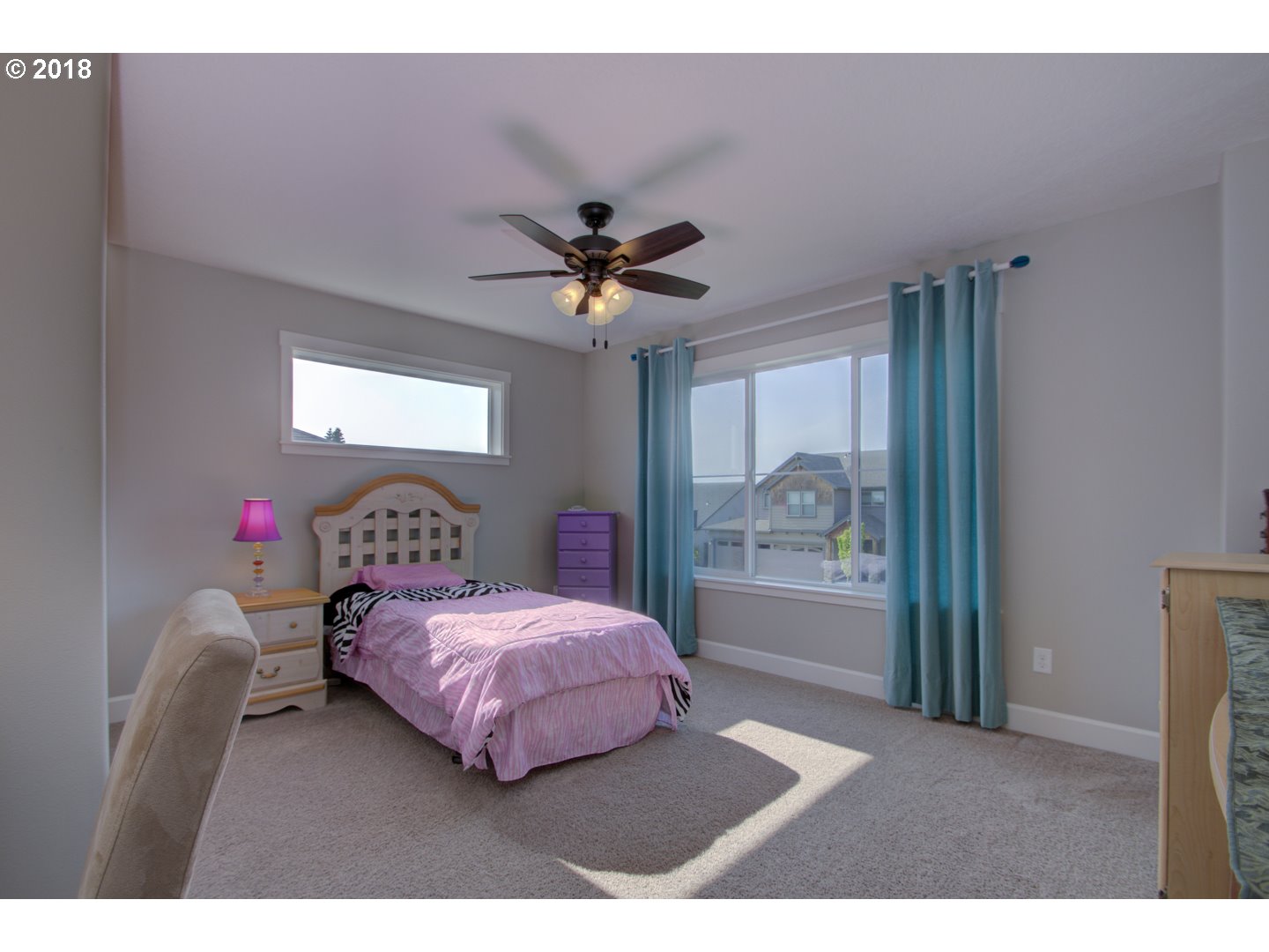 4821 North 6th Street Ridgefield, WA 98642 - Photo 14 of 29 a bedroom with a bed and a chandelier