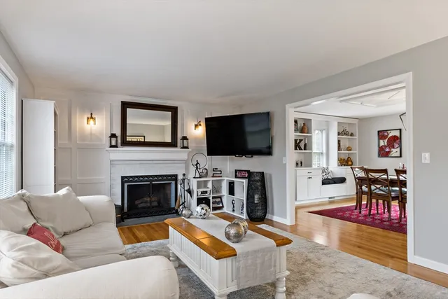 a living room with furniture fireplace and flat screen tv