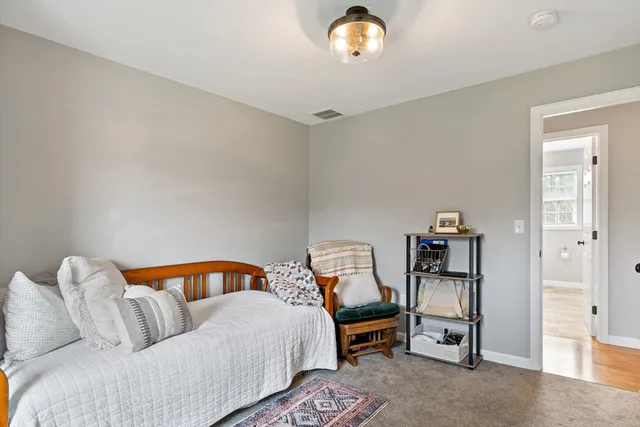 a bedroom with a bed and dresser