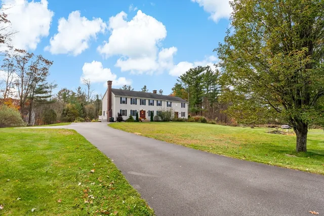 a view of green field with house in the background