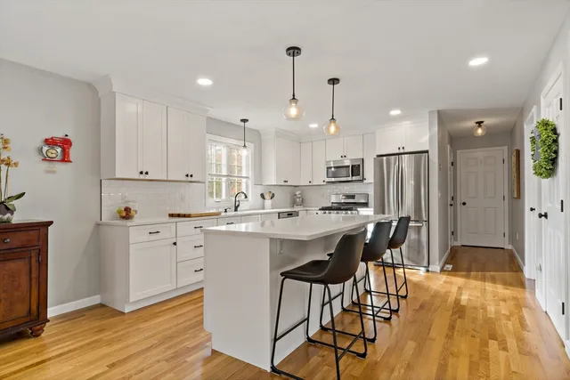 a kitchen with stainless steel appliances kitchen island granite countertop a sink and cabinets