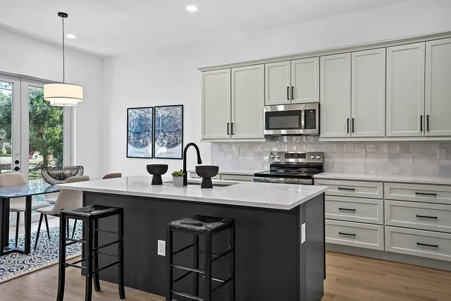 a kitchen with a stove a sink and a microwave