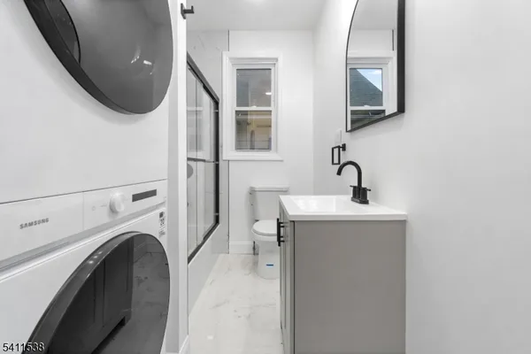 a bathroom with a sink a toilet and a mirror