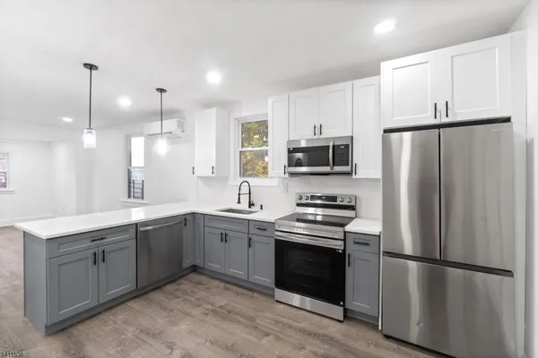 a kitchen with a sink stove and cabinets