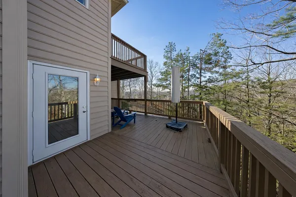 a view of a balcony with chairs and wooden fence