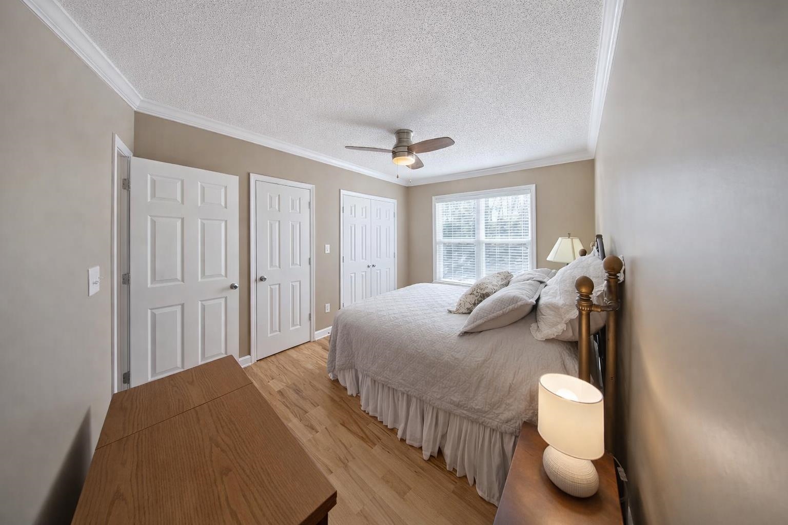 30 Point Grand Court Savannah, TN 38372 - Photo 12 of 40 a bedroom with a bed and a chandelier