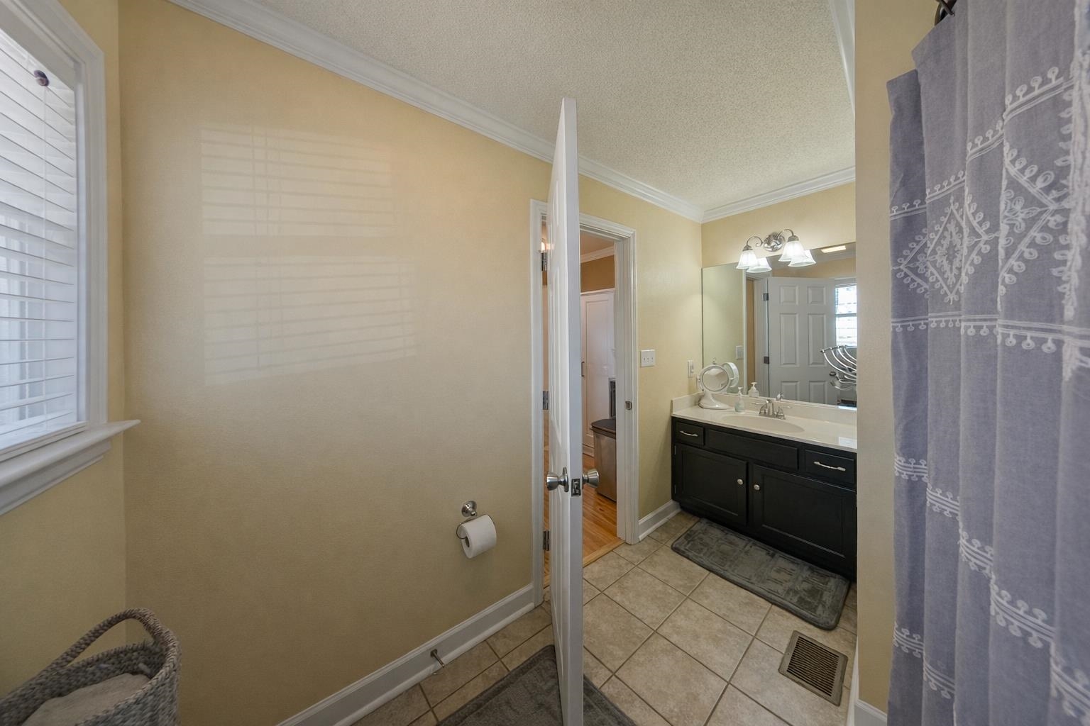 30 Point Grand Court Savannah, TN 38372 - Photo 17 of 40 a bathroom with a granite countertop sink mirror and vanity