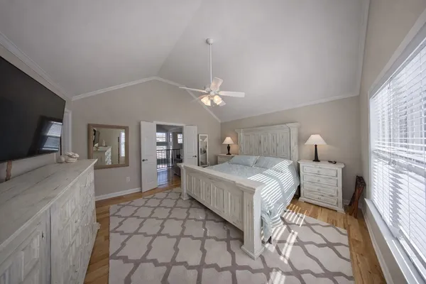 a spacious bedroom with a bed and a chandelier