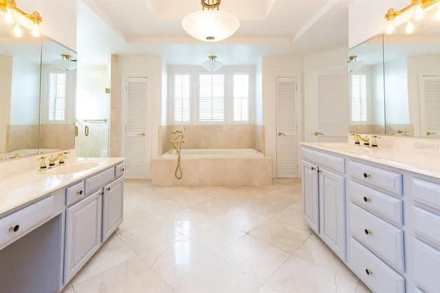 a spacious bathroom with a double vanity sink mirror double and bathtub
