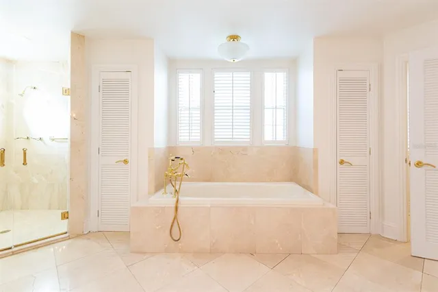 a bathroom with a bathtub and shower