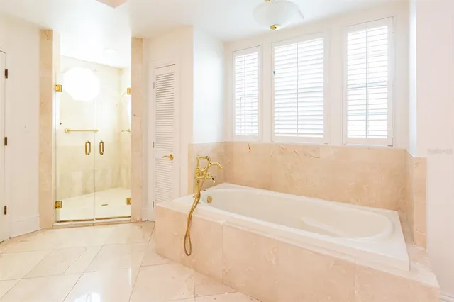 a white bath tub sitting next to a white sink