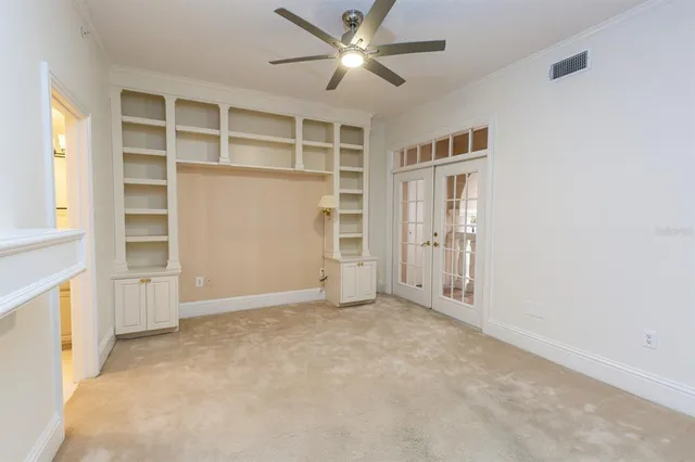 an empty room with closet and windows