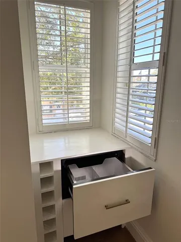 a room with a bench and a window