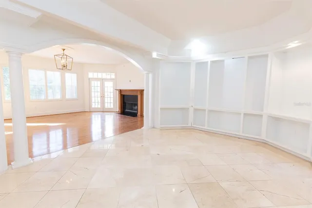 a view of empty room with a fireplace and windows