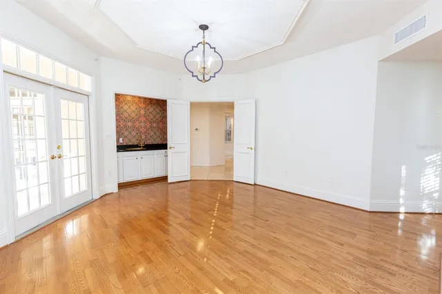 a view of empty room with wooden floor and window