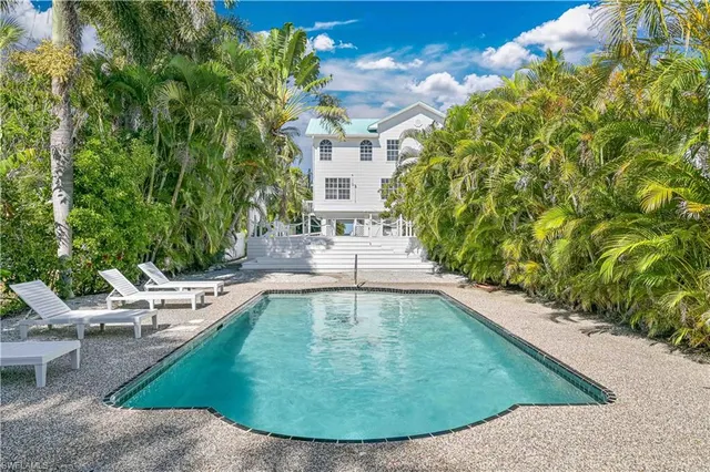 a kitchen with a sink a stove and a window
