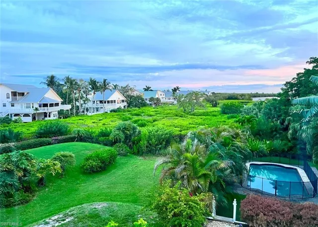 an aerial view of a house with a yard and outdoor seating