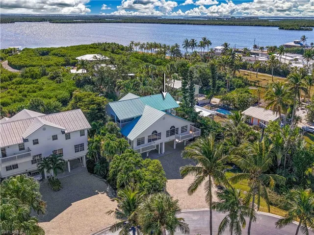 an aerial view of a house with a yard lake view