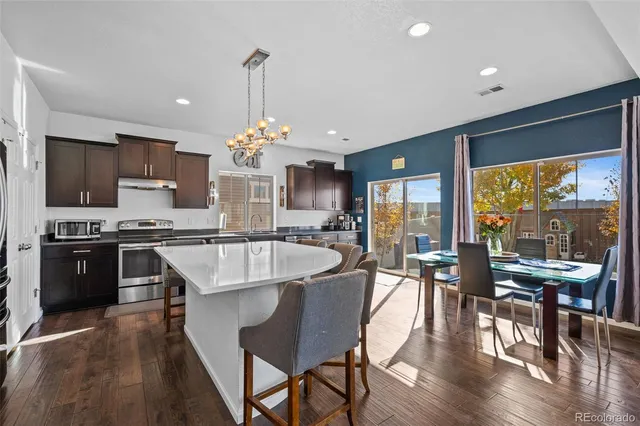 a large kitchen with a table and chairs