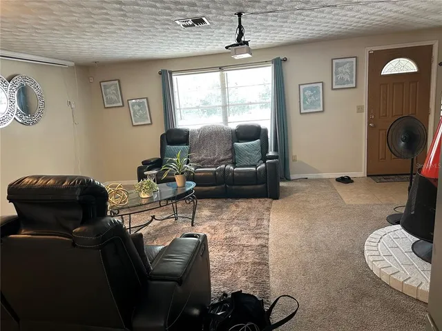 a living room with furniture a mirror and a window