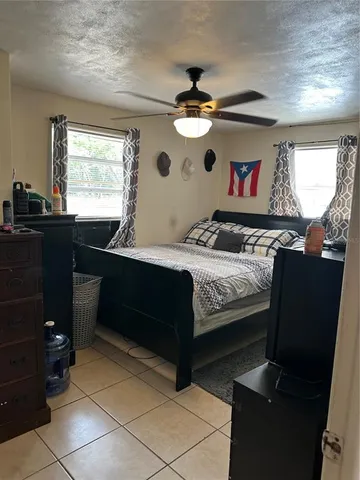 a bedroom with a bed and window