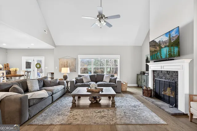 a living room with furniture a rug and a fireplace
