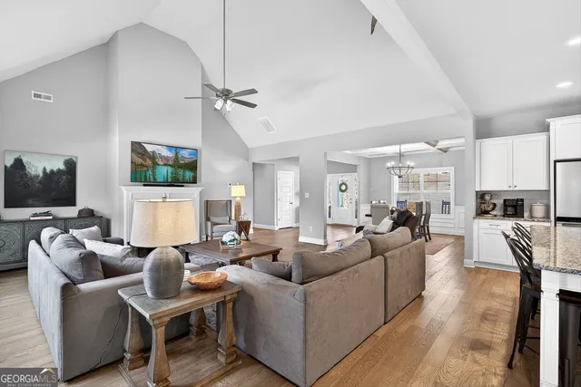 a living room with furniture a flat screen tv and a fireplace