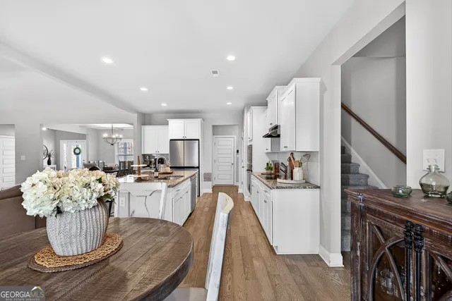 a kitchen with a table and chairs