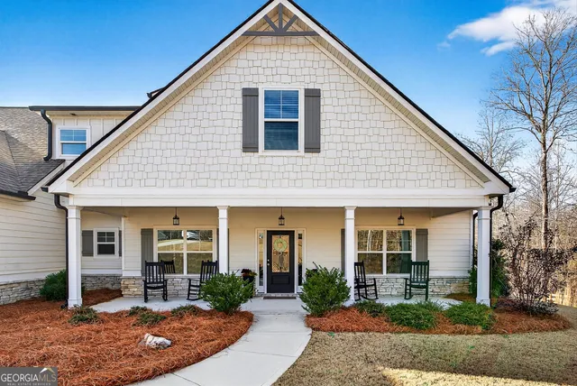 a front view of a house with garden and porch