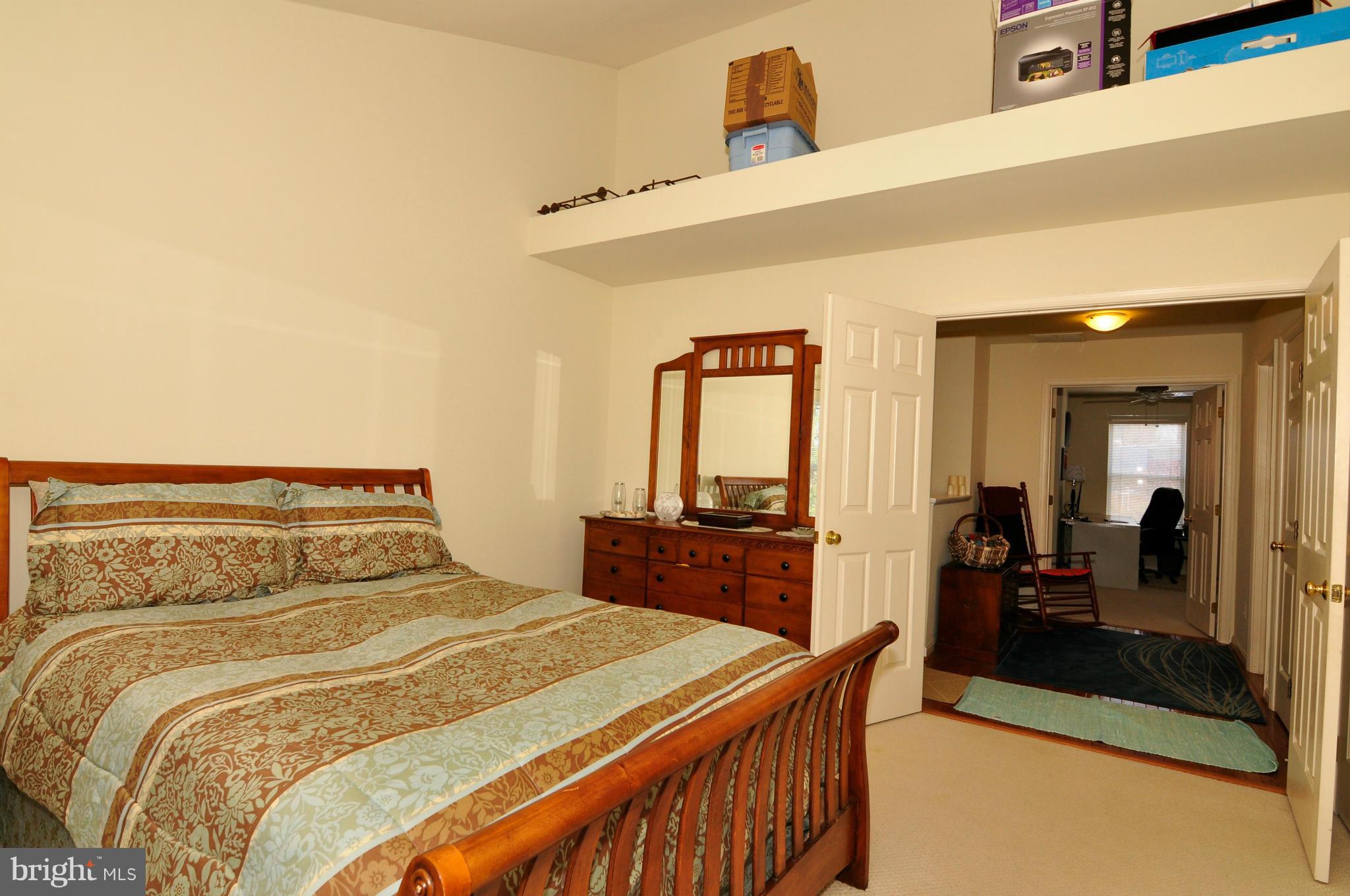 12095 Edgemere Circle Reston, VA 20190 - Photo 23 of 28 a bedroom with a bed and dresser with mirror