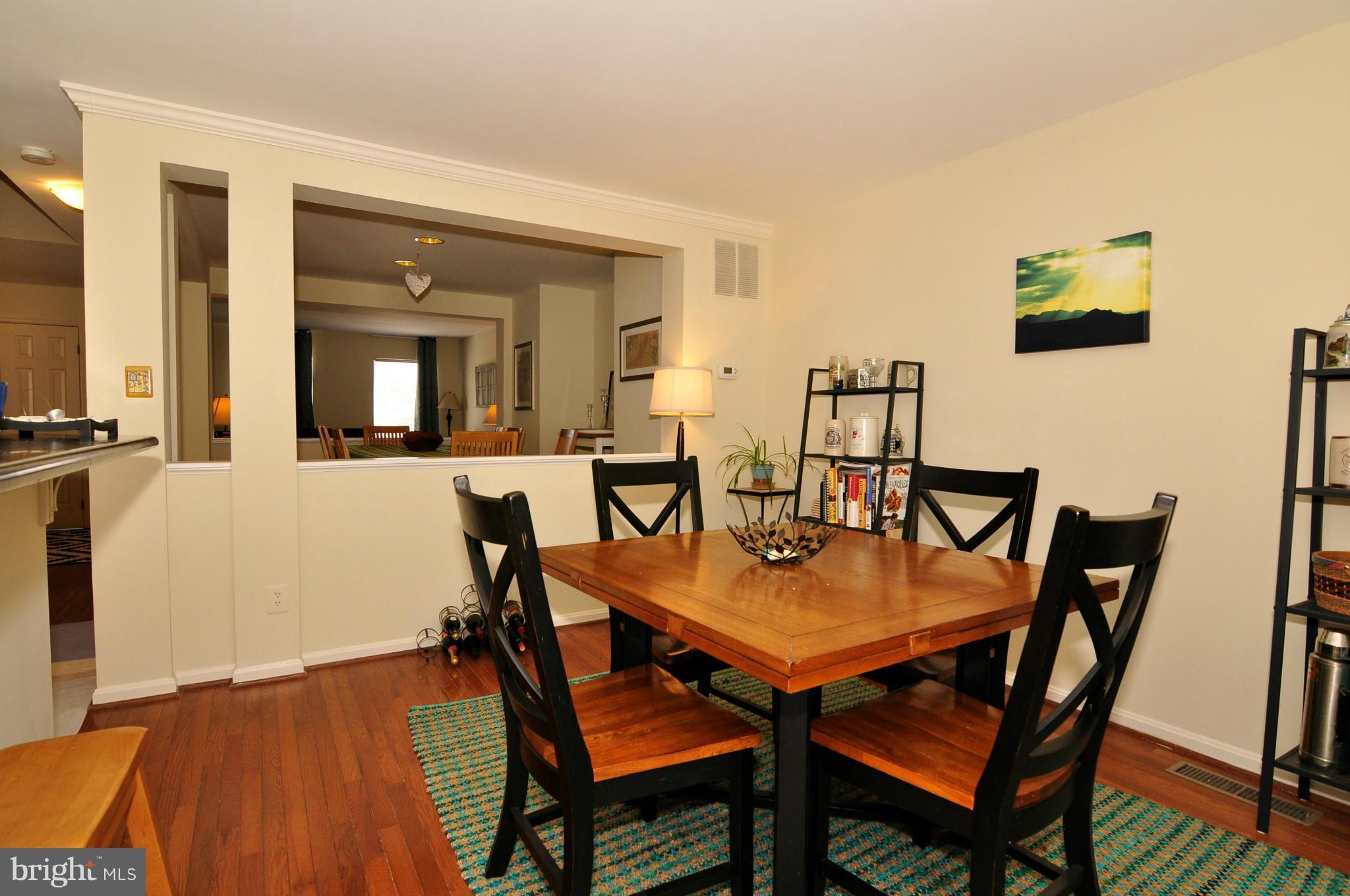 12095 Edgemere Circle Reston, VA 20190 - Photo 10 of 28 a view of a dining room with furniture and wooden floor