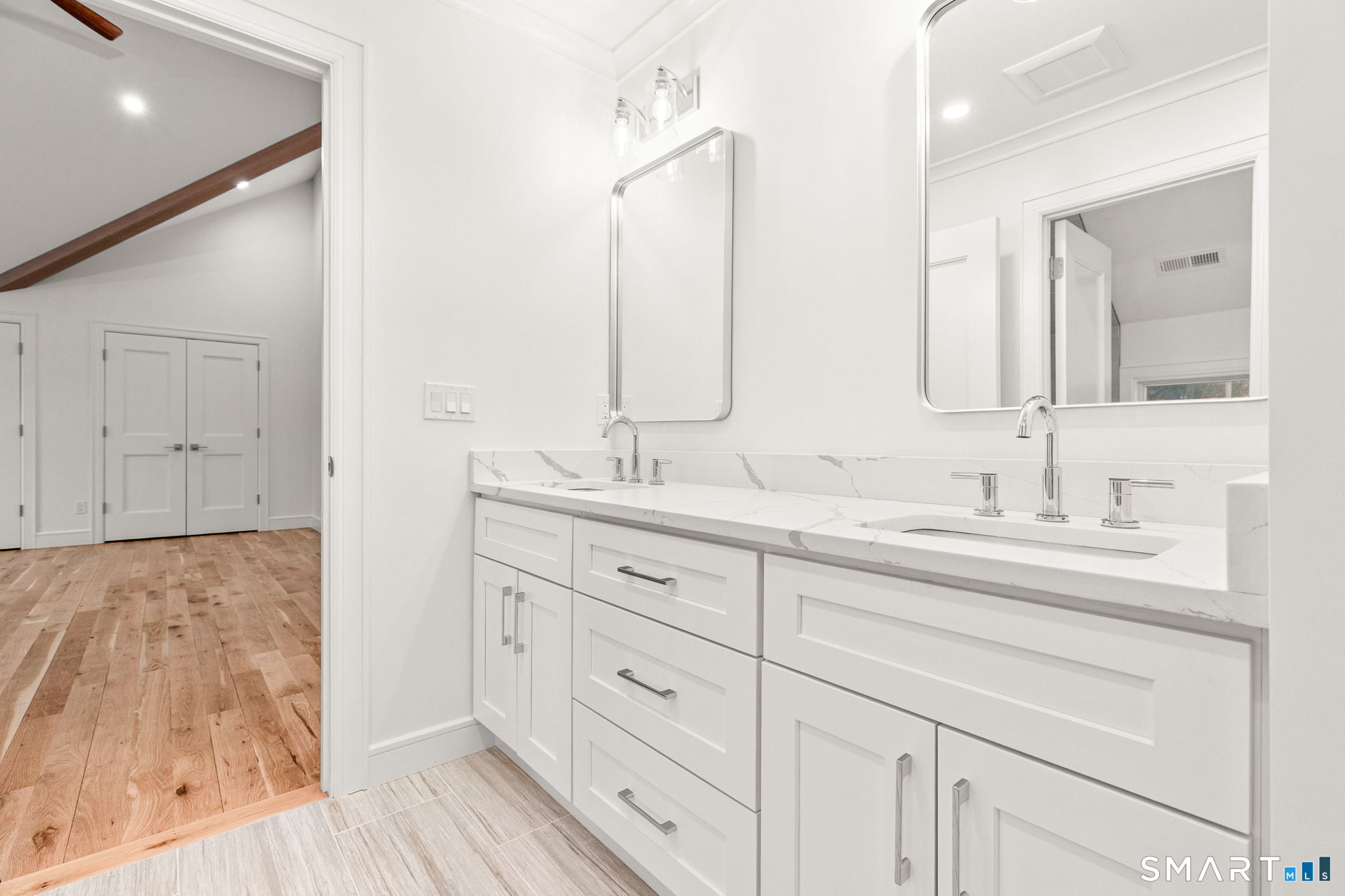 210 Pansy Road Fairfield, CT 06824 - Photo 21 of 26 a bathroom with double vanity sink and a mirror