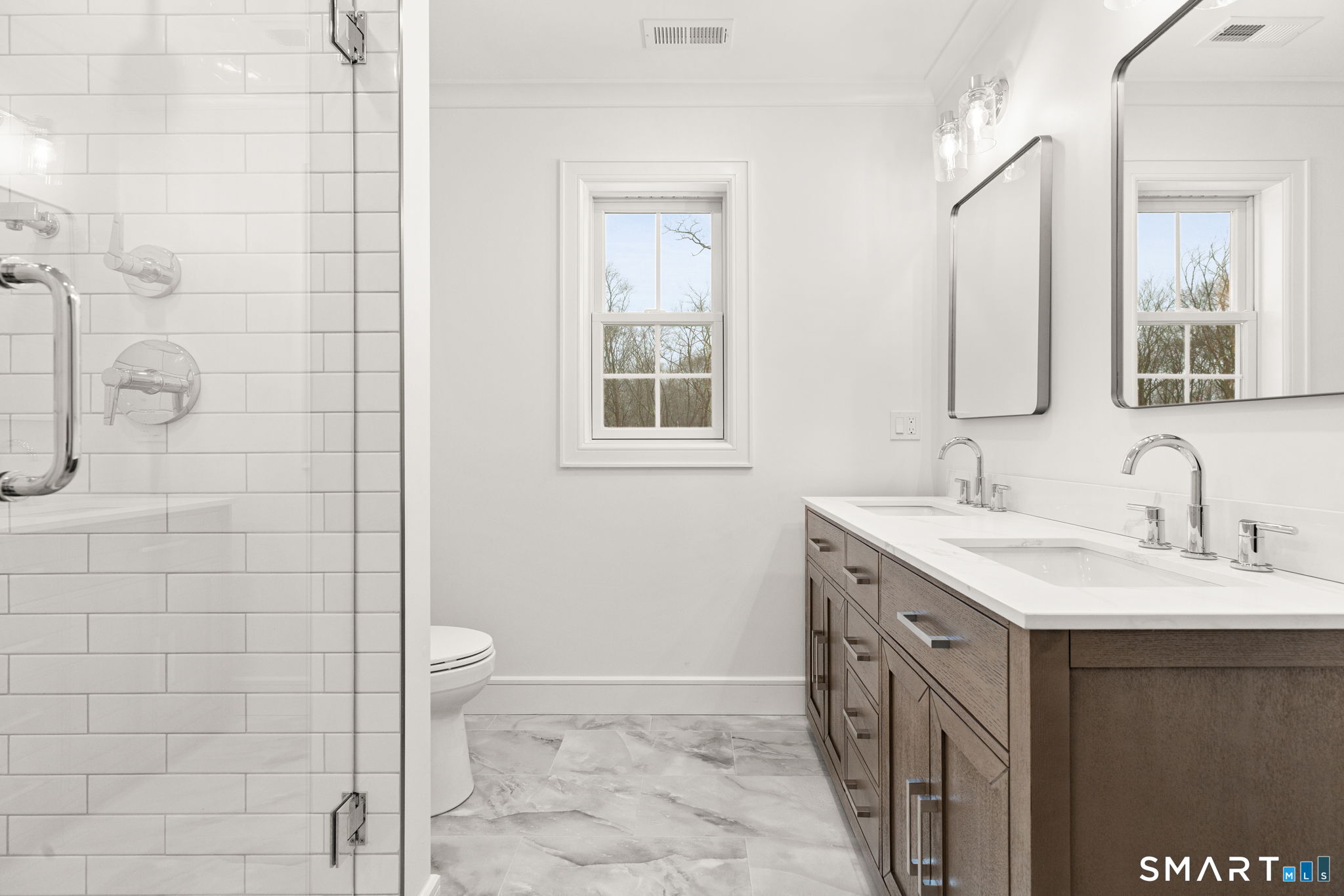 210 Pansy Road Fairfield, CT 06824 - Photo 22 of 26 a bathroom with a double vanity sink a toilet and a mirror