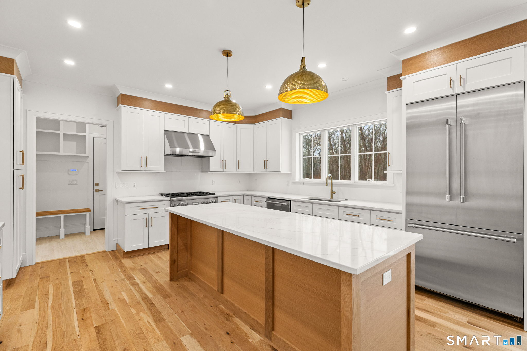 210 Pansy Road Fairfield, CT 06824 - Photo 6 of 26 a kitchen with stainless steel appliances granite countertop a sink a stove and a refrigerator