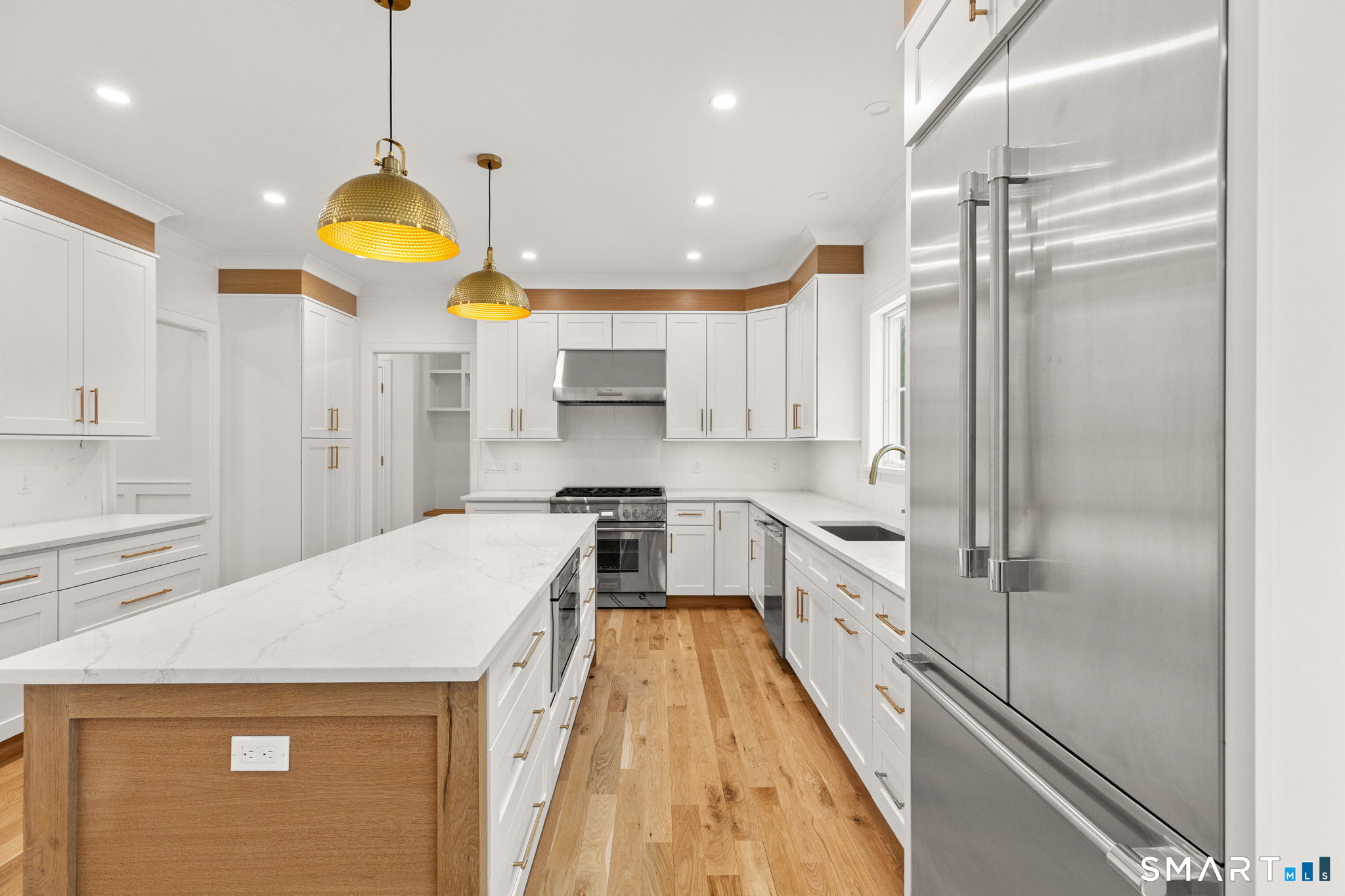 210 Pansy Road Fairfield, CT 06824 - Photo 7 of 26 a kitchen with stainless steel appliances a stove a refrigerator and a kitchen island