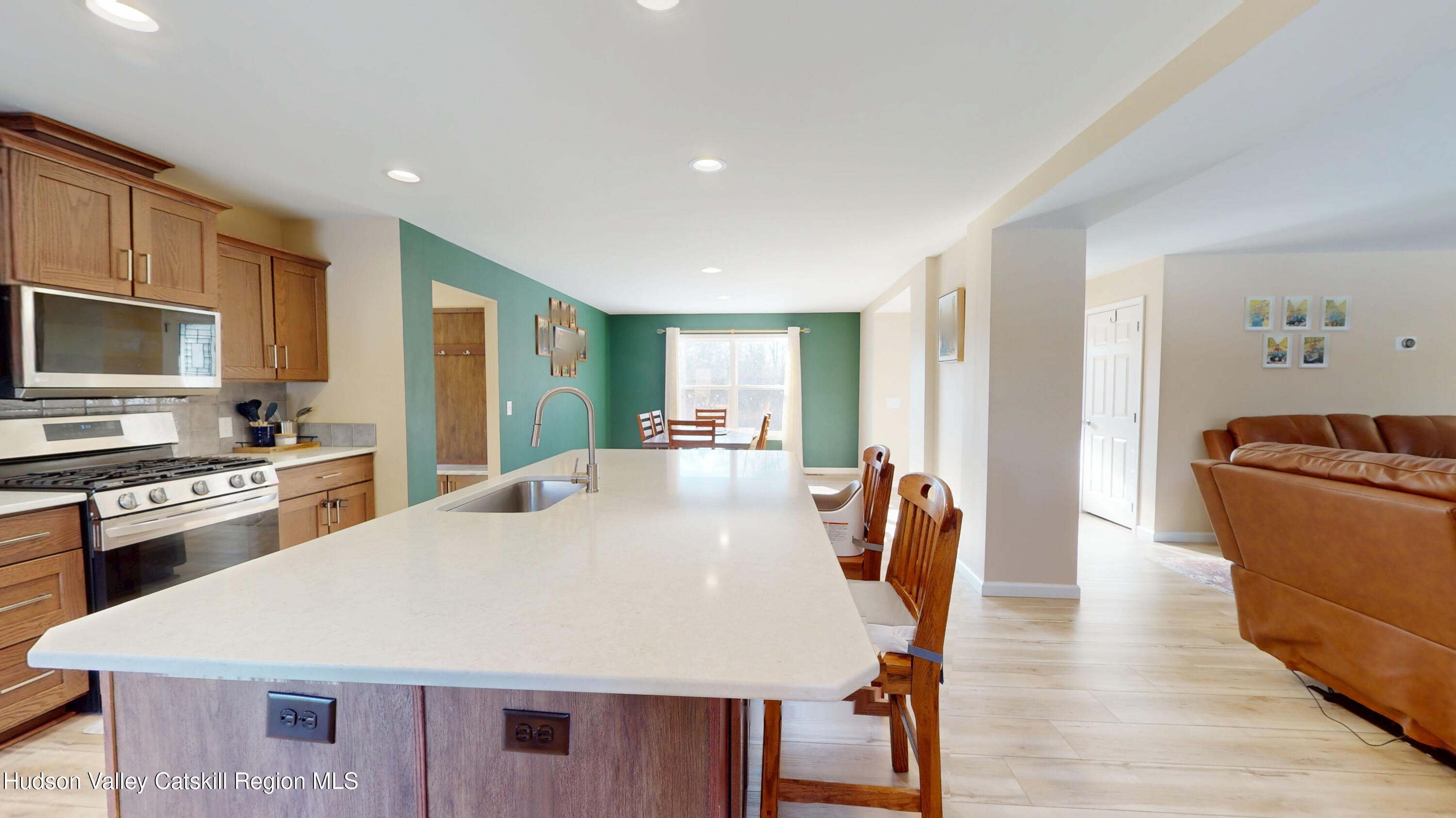 1608 Sleepy Hollow Road Athens, NY 12015 - Photo 3 of 46 a large kitchen with kitchen island a stove a sink a refrigerator dining table and chairs