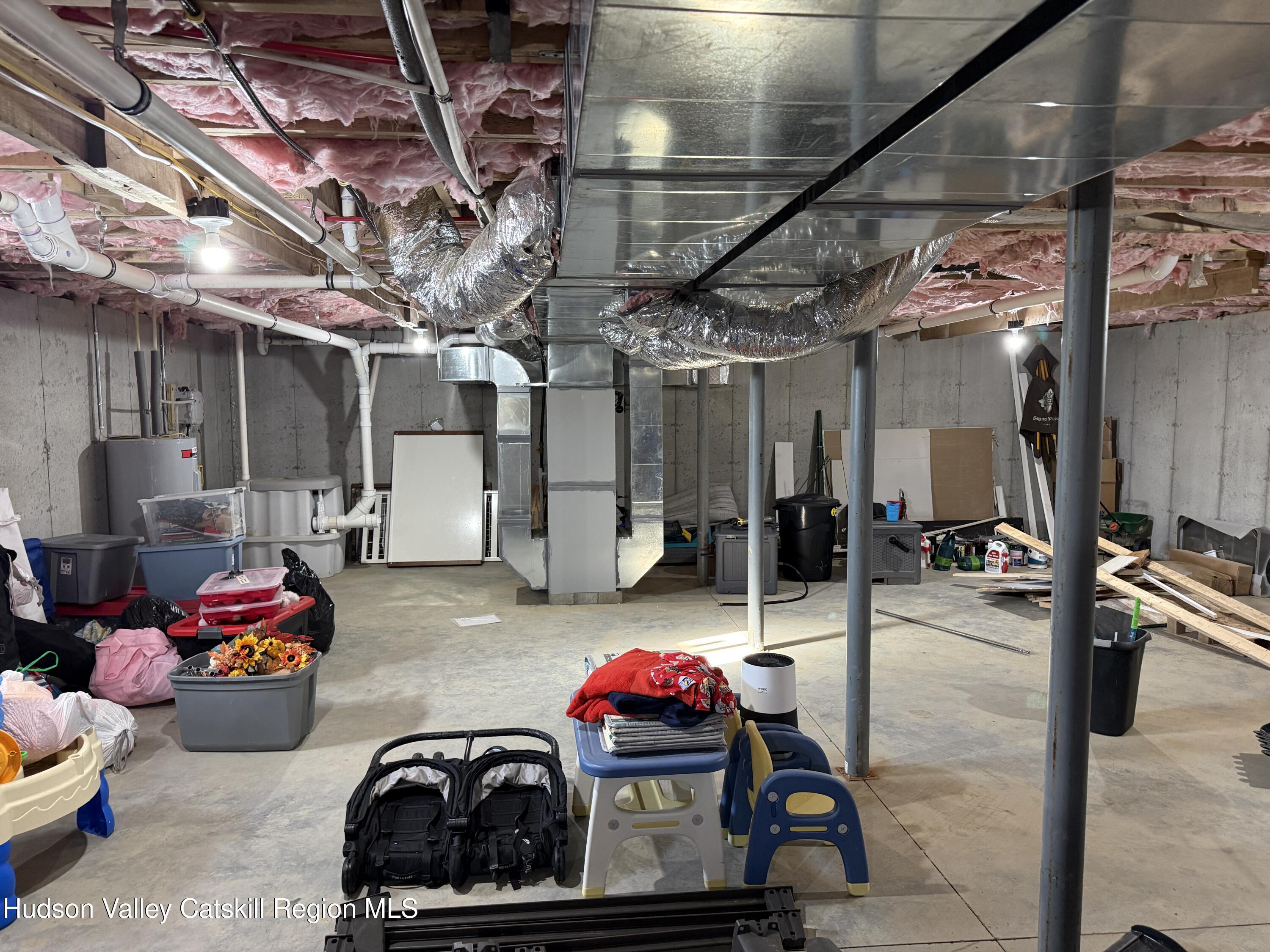 1608 Sleepy Hollow Road Athens, NY 12015 - Photo 38 of 46 a living room with lots of furniture and a chandelier