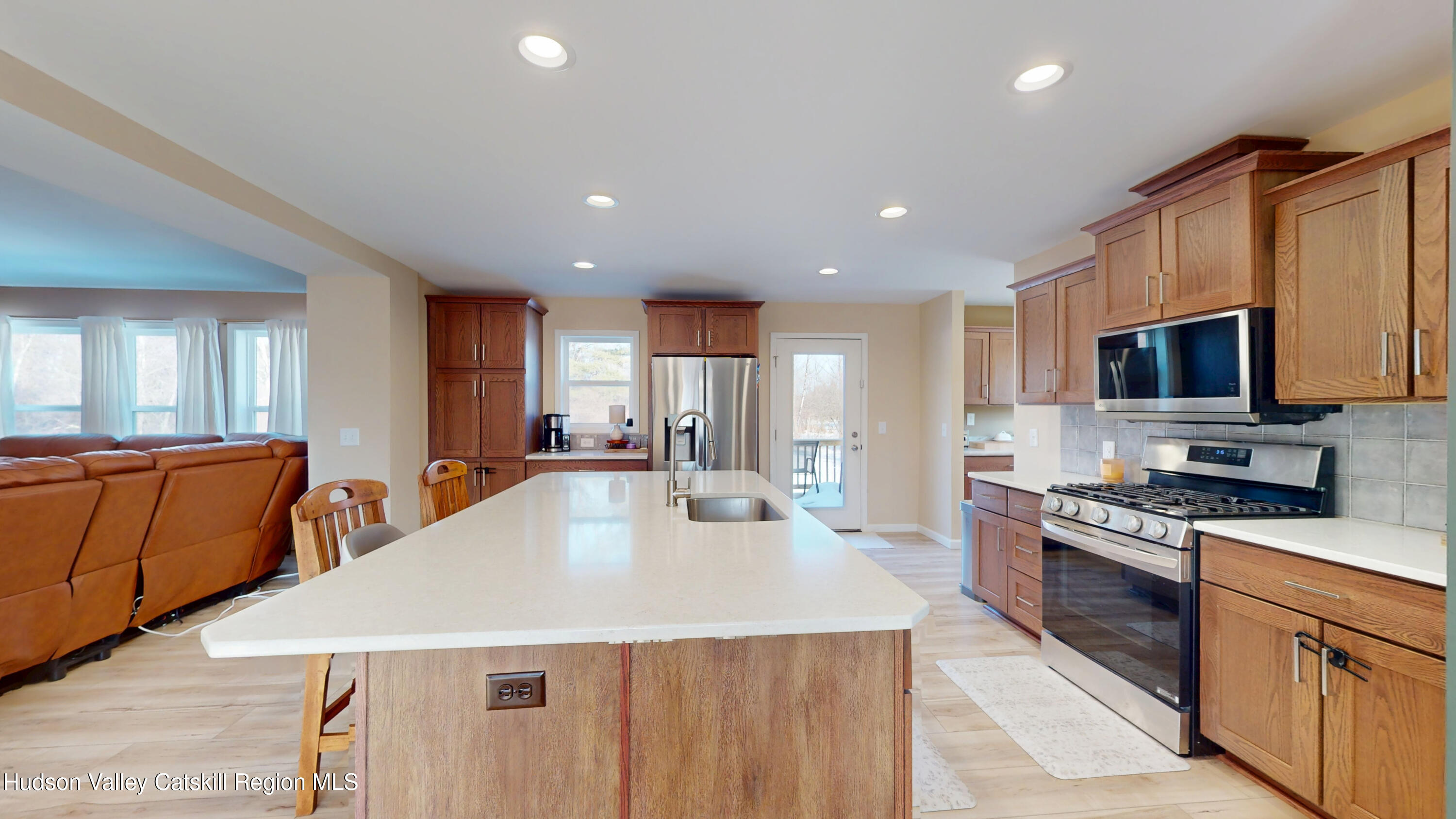 1608 Sleepy Hollow Road Athens, NY 12015 - Photo 8 of 46 a kitchen with stainless steel appliances wooden floor dining table and chairs