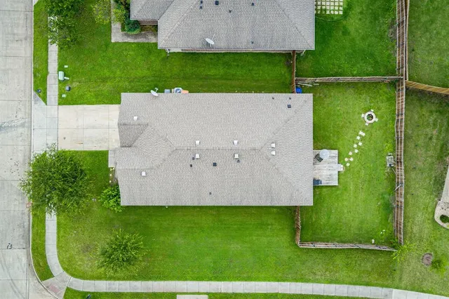 an aerial view of a house with a garden and swimming pool