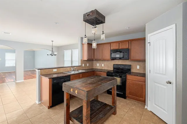 a kitchen with a stove a sink and a refrigerator