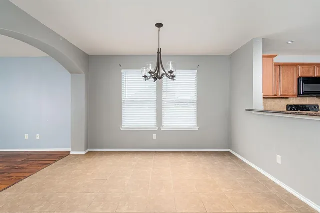 a kitchen with stainless steel appliances granite countertop a stove and a refrigerator
