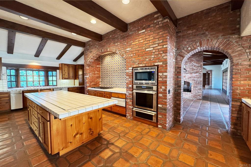 5443 Calzada Del Bosque Rancho Santa Fe, CA 92067 - Photo 16 of 56 a kitchen that has a stove and a table