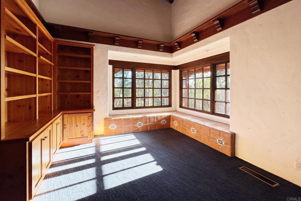 5443 Calzada Del Bosque Rancho Santa Fe, CA 92067 - Photo 29 of 63 a view of an empty room with a window and wooden floor