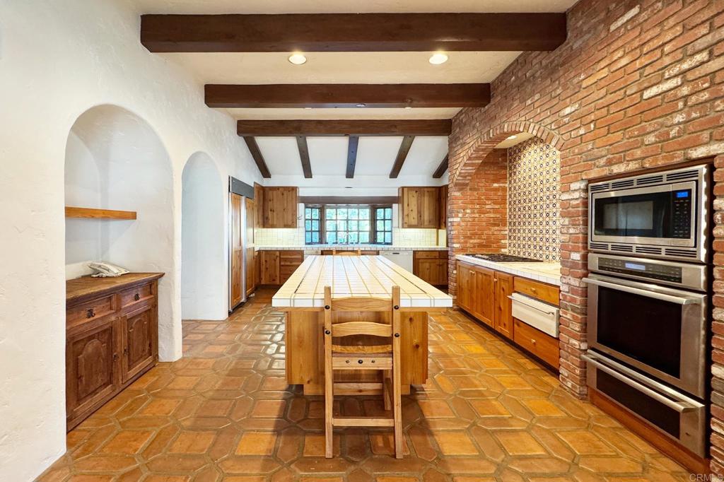 5443 Calzada Del Bosque Rancho Santa Fe, CA 92067 - Photo 38 of 63 a kitchen with a stove a sink and a microwave
