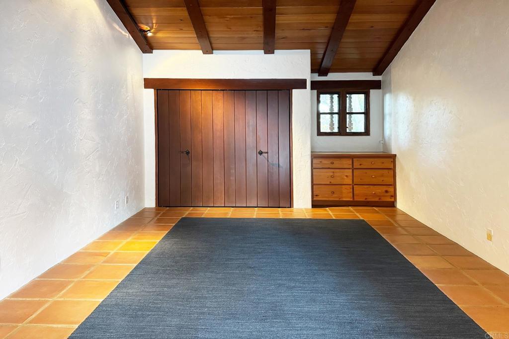 5443 Calzada Del Bosque Rancho Santa Fe, CA 92067 - Photo 43 of 63 a view of an empty room with wooden floor and a window