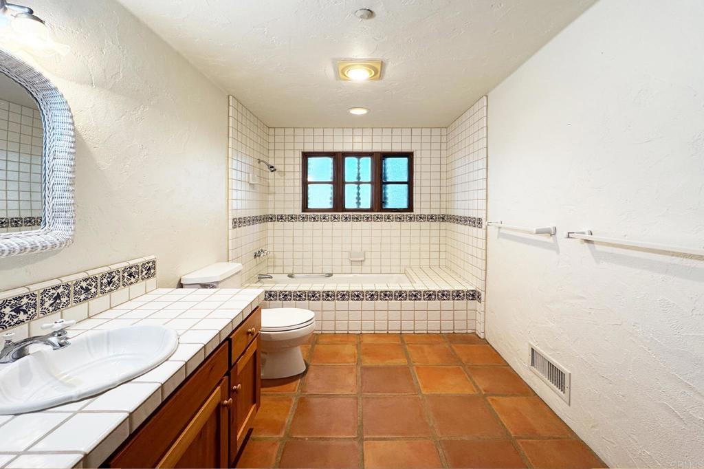 5443 Calzada Del Bosque Rancho Santa Fe, CA 92067 - Photo 49 of 62 a bathroom with a tub sink and mirror