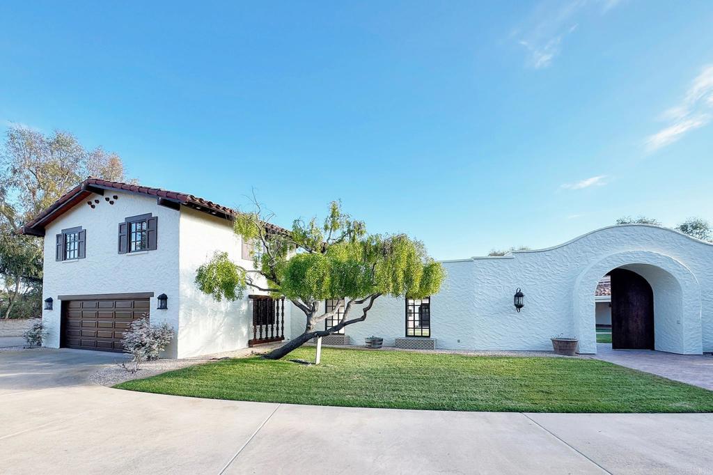 5443 Calzada Del Bosque Rancho Santa Fe, CA 92067 - Photo 5 of 56 a front view of a house with a garden and yard